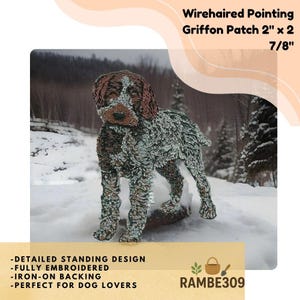 May include: Embroidered Wirehaired Pointing Griffon patch, 2" x 2 7/8", featuring a detailed standing design. The patch has an iron-on backing. The dog has brown and white fur. The background shows a snowy landscape.