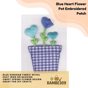 May include: Embroidered patch featuring a blue gingham flower pot with heart-shaped flowers in shades of blue and green. The patch includes the text "Blue Heart Flower Pot Embroidered Patch" and additional text about the design and application.