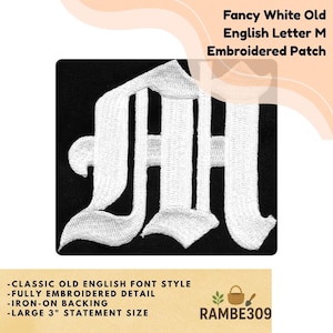 May include: A black embroidered patch featuring a fancy white Old English letter "M". The patch has an iron-on backing and is 3 inches in size. The text on the patch reads "Fancy White Old English Letter M Embroidered Patch".