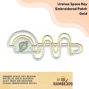 May include: Gold embroidered patch with a unique space key design. The patch features metallic gold accents and a clean embroidered detail. The text "Uranus Space Key Embroidered Patch Gold" is at the top. The patch has easy iron-on backing.