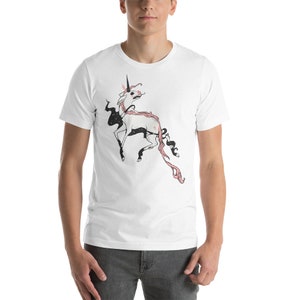 May include: White t-shirt with a black and pink illustration of a unicorn with a starry mane and tail.