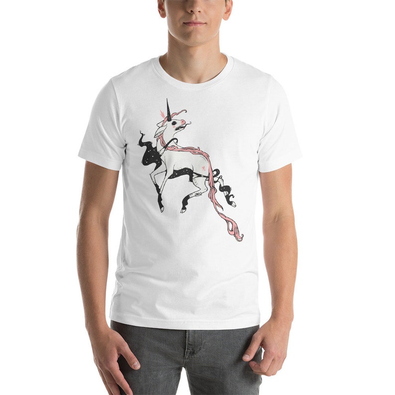 May include: White t-shirt with a black and pink illustration of a unicorn with a starry mane and tail.
