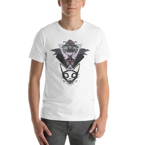 May include: White t-shirt with a graphic print of a woman with a floral crown, two ravens, and a cat with an all-seeing eye. The graphic is in shades of purple, black, and white.