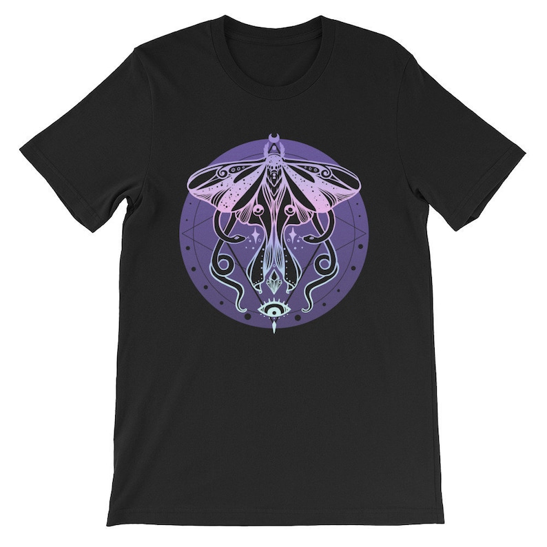 May include: Black t-shirt with a graphic of a moth with a pink and purple gradient, surrounded by a circle with a geometric pattern and a single eye in the center.