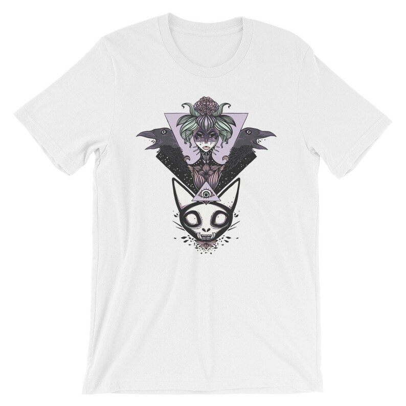 May include: White t-shirt with a black and white illustration of a woman with a floral crown, two ravens, and a cat with an all-seeing eye. The illustration is surrounded by a triangle.
