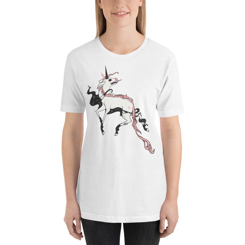 May include: White t-shirt with a black and pink illustration of a unicorn with a star on its side.
