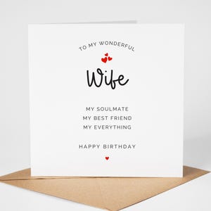 May include: A white birthday card with the words "To my wonderful Wife" and "Happy Birthday" in black script. The card includes the phrases "My soulmate, My best friend, My everything" and small red heart accents. The card rests on a brown envelope.