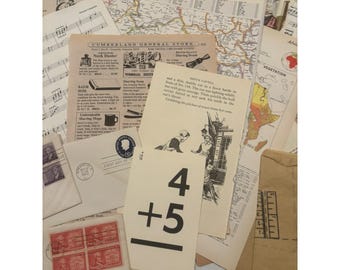 May include: A collection of vintage ephemera, including sheet music, maps, and old advertisements. A card with the numbers "4 + 5" is visible. The items are arranged in a layered composition, with a variety of textures and colors.