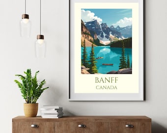May include: A framed art print featuring a scenic view of Banff, Canada. The artwork depicts a turquoise lake surrounded by mountains and evergreen trees under a blue sky. The text "BANFF CANADA" is printed at the bottom.