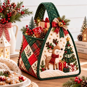 May include: A quilted fabric basket featuring a festive holiday design with a reindeer, a Christmas tree, and wrapped gifts. The basket has a green and red plaid pattern on the sides and a top handle, decorated with a bow and a small bell.