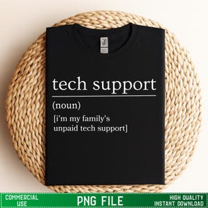May include: Black t-shirt with the text "tech support" in white, followed by a definition. The definition reads "(noun) [i'm my family's unpaid tech support]" The shirt is displayed on a woven, circular placemat.