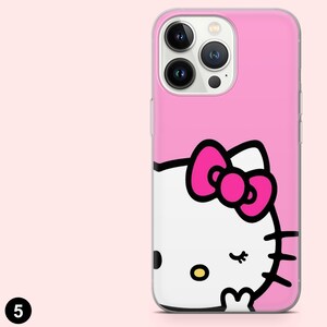 Puede incluir: Funda de tel&eacute;fono rosa con dise&ntilde;o de Hello Kitty. La funda tiene un borde transparente y un fondo rosa. El gr&aacute;fico de Hello Kitty incluye un lazo rosa, bigotes negros y una nariz amarilla.