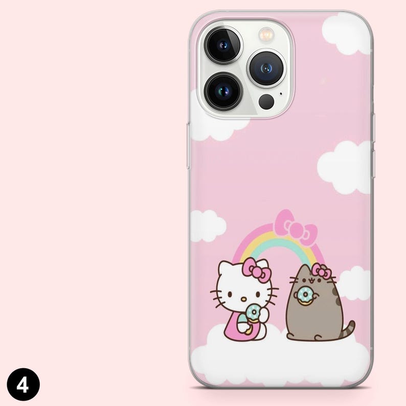 May include: Pink phone case featuring a cartoon illustration of Hello Kitty and a gray cat with donuts, a rainbow, and white clouds. The case has a clear border and a pink background.