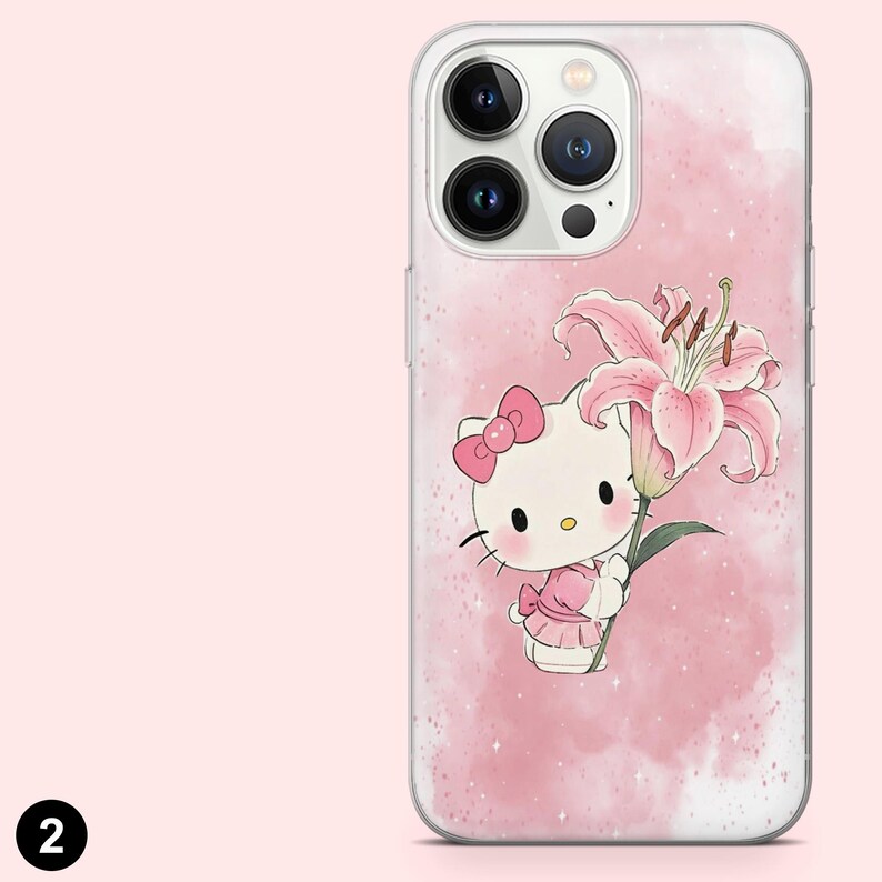 May include: A clear phone case featuring a pink watercolor background with a cartoon illustration of a white cat with a pink bow and dress holding a pink lily flower. The phone case has a clear border.