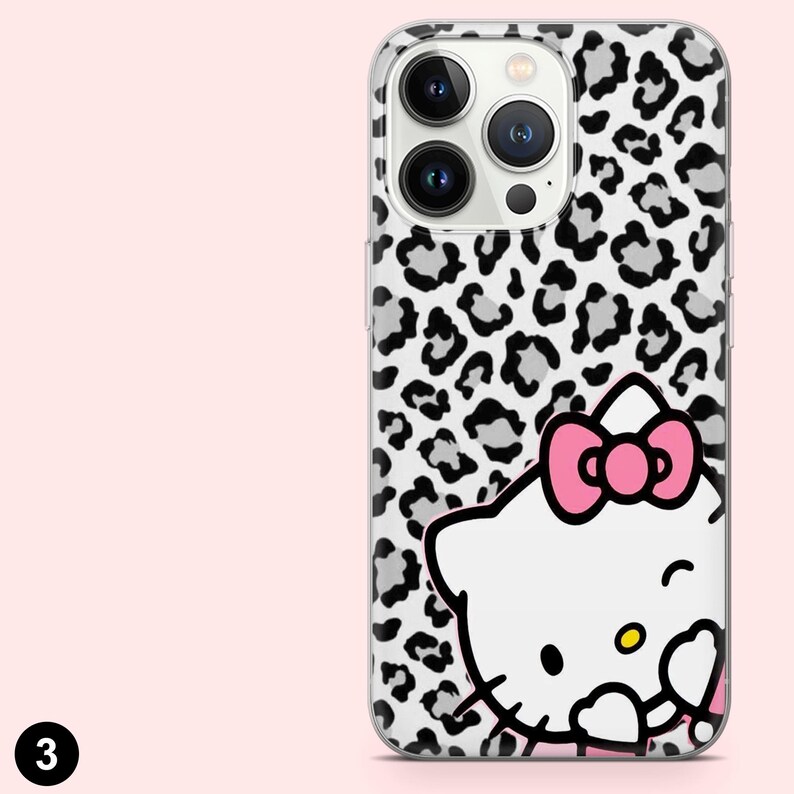 May include: A clear phone case with a black and white leopard print pattern. The case features a white cartoon cat with a pink bow. The phone case has a camera cutout and a black number 3 in the bottom left corner.