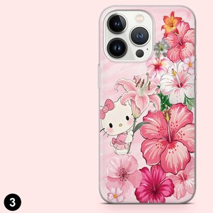 May include: A pink phone case featuring a floral design with pink hibiscus flowers, lilies, and a Hello Kitty character. The case has a clear border and a pink marble-like background.