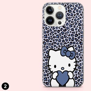 May include: A phone case featuring a blue and black leopard print pattern. The case has a white cartoon character with a blue bow and a blue heart. The phone case is designed to fit a smartphone.
