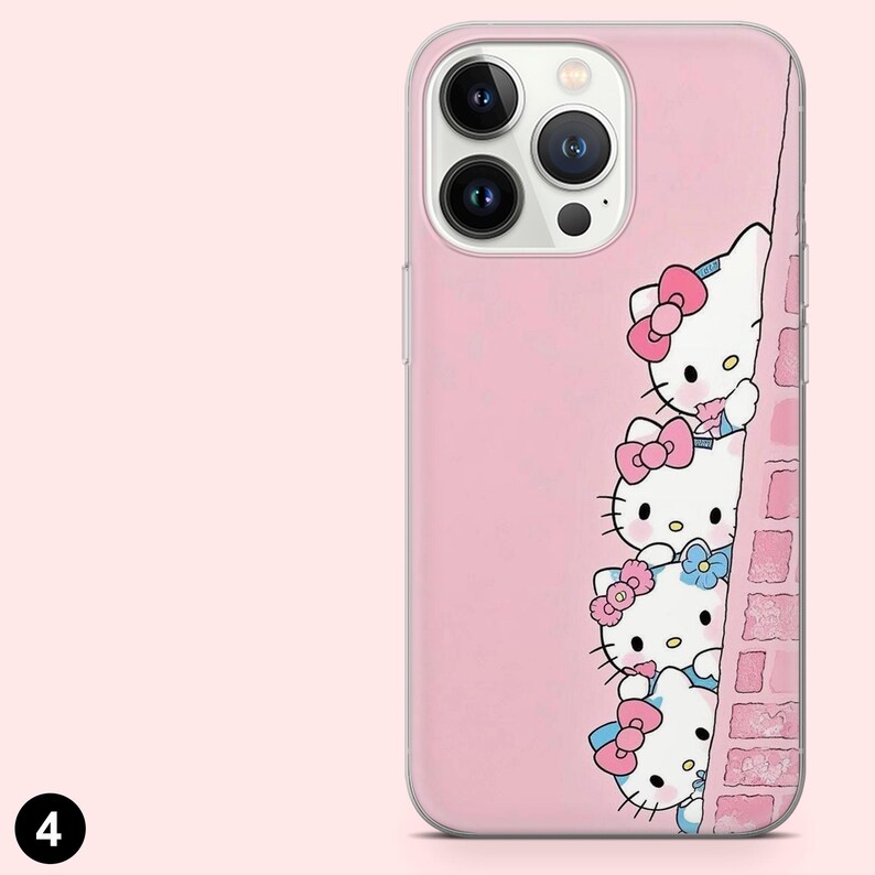 May include: Pink phone case featuring a design of Hello Kitty characters peeking from behind a brick wall. The case has a clear border and a pink background. The Hello Kitty characters have pink and blue bows.