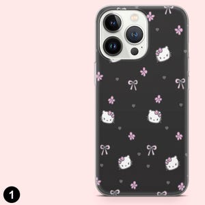 May include: Black phone case featuring a repeating pattern of Hello Kitty faces, pink bows, and flowers. The case has a clear border and is designed for a smartphone. The background is black.