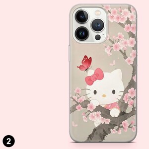 May include: Clear phone case with a Hello Kitty design. The case features Hello Kitty in a pink outfit, a pink bow, and a red butterfly, set against a backdrop of cherry blossoms. The case has a clear border.