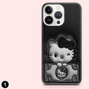 May include: Black iPhone case with a 3D embossed Hello Kitty design. The design includes a bow, winking eye, and a dollar bill with Hello Kitty's face. The case has a clear border and is made of a durable material.