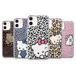 May include: A collection of five phone cases featuring Hello Kitty designs. The cases showcase various patterns, including leopard print and Hello Kitty illustrations with bows and hearts. The cases are in shades of brown, blue, pink, and white.