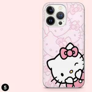 May include: A pink phone case featuring a repeating pattern of bows and a smiling cartoon cat with a pink bow. The case has a clear border and a camera cutout.
