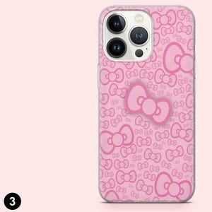 May include: Pink phone case with a repeating bow pattern and a large bow accent. The case is designed to fit a smartphone and has a clear border. The background is a solid light pink.