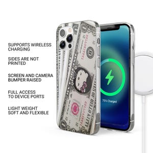 May include: A clear phone case featuring a dollar bill design with a Hello Kitty graphic. The phone case is shown on a smartphone with a charging screen. Text on the case reads "HELLOKITTYI". The case supports wireless charging and has full access to device ports.