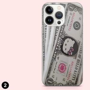 May include: Clear phone case featuring a design that mimics a one-dollar bill, with the Hello Kitty character replacing George Washington. The case has a pink bow and the text "HELLO KITTYI". The phone case is designed to fit a smartphone.