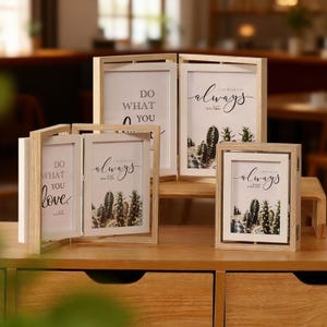 May include: A collection of wooden picture frames, some open and some closed, displaying inspirational quotes and cactus imagery. The frames are light-colored wood with white matting, creating a neutral and inviting aesthetic. The text includes "Do what you love" and "always".