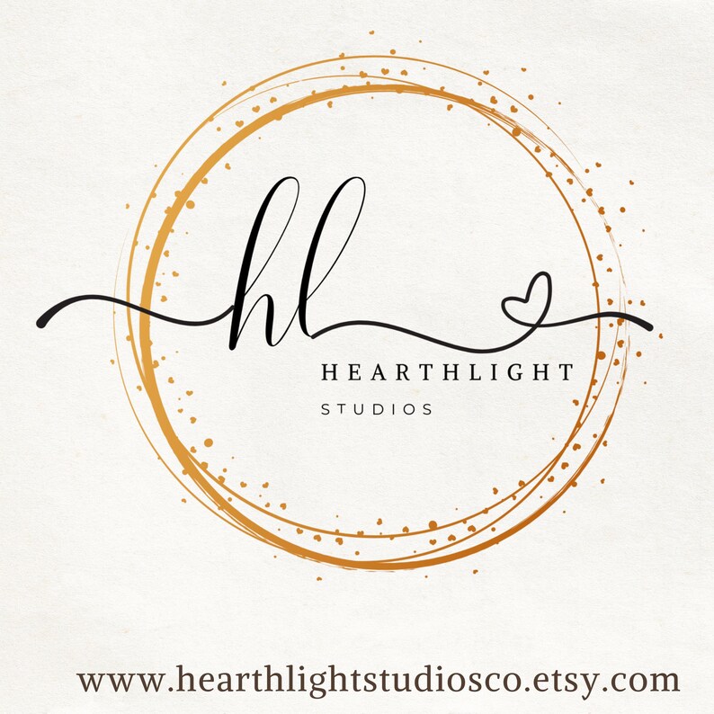 May include: A circular logo featuring a gold-colored hand-drawn ring with small dots and a heart shape. The black text reads hl, HEARTHLIGHT, and STUDIOS, with the website address www.hearthlightstudiosco.etsy.com printed at the bottom of the image.