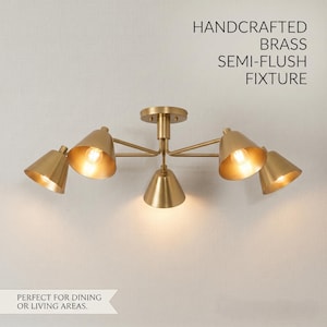 May include: Handcrafted brass semi-flush fixture with five cone-shaped shades. The fixture is gold-toned and emits a warm light. Text on the image reads "Handcrafted Brass Semi-Flush Fixture".