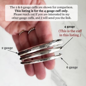 May include: Three silver-colored metal cuff bracelets of varying thicknesses, labeled 2 gauge, 4 gauge, and 6 gauge. The text states: The 2 & 6 gauge cuffs are shown for comparison. This listing is for the 4 gauge cuff only. 4 gauge (This is the cuff in this listing.)