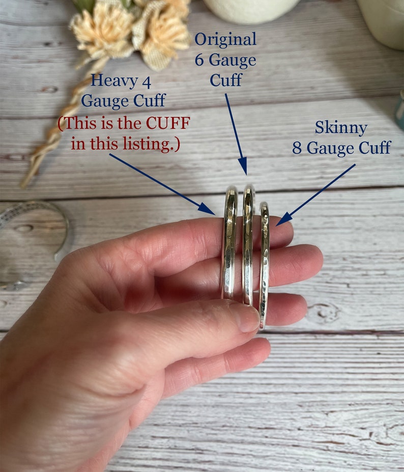 May include: Three silver-colored metal cuffs of varying thicknesses are displayed. Text labels identify them as a Heavy 4 Gauge Cuff, an Original 6 Gauge Cuff, and a Skinny 8 Gauge Cuff. The Heavy 4 Gauge Cuff is highlighted as the item in this listing.