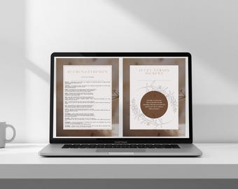 May include: A laptop displays two pages of text and graphics. The left page has text, and the right page has a circular design with text. A white mug and a geometric planter with a succulent sit on the table.