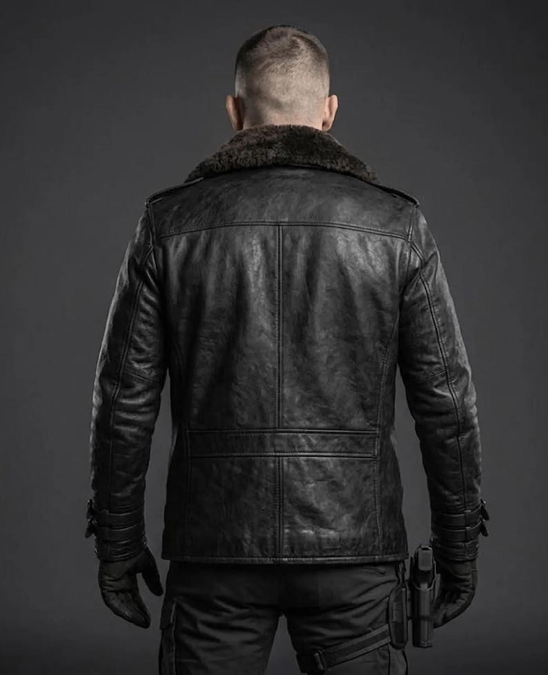 May include: A black leather jacket featuring a dark brown faux fur collar, long sleeves with adjustable buckled cuffs, and a paneled back design. The jacket is worn over black trousers with a holster attached to the thigh, and black gloves.