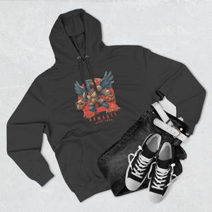 May include: Dark gray hooded sweatshirt with a graphic of a bird-like creature with the text "ARMADYL KREE'ARRA". The sweatshirt is paired with black jeans, a white belt, and black and white sneakers.