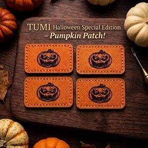 May include: Four rectangular orange patches with a textured surface, each featuring a black engraved graphic of a jack-o'-lantern with a menacing expression. The text TUMI Halloween Special Edition - Pumpkin Patch! is printed above the patches.