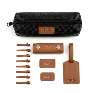 May include: A black zipped pencil case with a textured surface and a brown rectangular patch labelled TEXT. Included are eight brown leather cord ties, a brown snap-button key organiser, two small brown rectangular tags, and a luggage tag, all labelled TEXT.