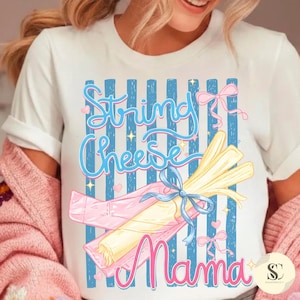 May include: White t-shirt with a graphic design featuring the words "String Cheese Mama" in pink and blue. The design includes a bundle of string cheese tied with a blue ribbon and pink wrapping.