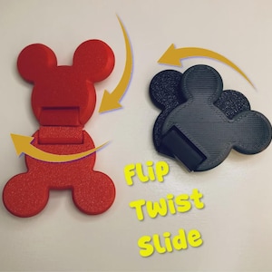 May include: A red and a black mouse-shaped plastic clip, each featuring a hinged design. Yellow arrows indicate movement, and the yellow text reads Flip, Twist, Slide. The clips have a textured surface and a functional mechanism for securing items.