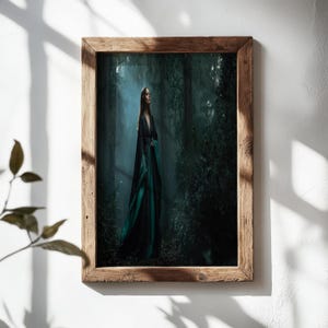 May include: A framed print depicting a woman in a dark green and black gown in a forest setting. The artwork is encased in a rustic wooden frame. The scene is lit by a soft, ethereal light, creating a fantasy art aesthetic.