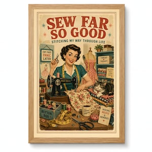 May include: A framed vintage-style print with the text "SEW FAR SO GOOD" and "Stitching My Way Through Life." The image features a woman sewing, a cat, and sewing supplies. The print has a wooden frame.