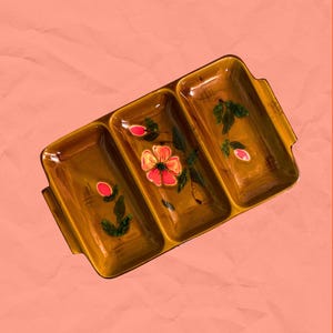 May include: A rectangular, three-section ceramic serving dish with a glossy brown glaze. The dish features hand-painted floral motifs in shades of pink, orange, and green, with distinct compartments separated by raised dividers and integrated side handles.