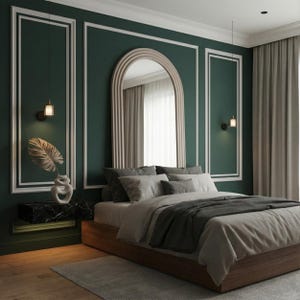 May include: A modern bedroom with a dark green accent wall and white trim. A large arched mirror hangs above the bed, which has gray bedding and a wooden frame. A decorative vase with a leaf sits on a black marble nightstand.