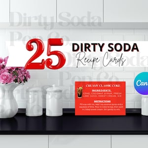 May include: A display featuring "25 Dirty Soda Recipe Cards" with a red number 25 and a banner with the text "Dirty Soda Recipe Cards". A red recipe card with instructions and ingredients for "Creamy Classic Coke" is visible.