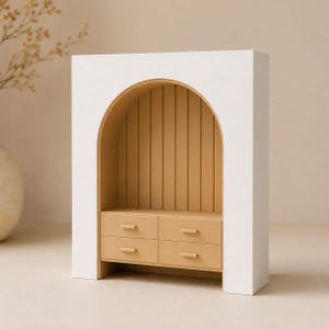 May include: A white arched display shelf featuring a tan interior with vertical paneling and four small drawers. The structure has a smooth matte finish and a rectangular outer frame that surrounds the curved, recessed storage area.