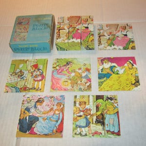 May include: Vintage "Story Book Puzzle Blocks" set. The set includes a light blue box with the words "Story Book Puzzle Blocks" printed on it. The set includes a collection of colorful puzzle blocks and individual puzzle pieces, each depicting scenes from fairy tales.