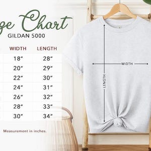 a size chart for a GILDA 5000 t-shirt, with measurements for different sizes ranging from S to M. The chart includes a tie-dye t-shirt hanging on a wooden hanger, and there is a basket in the background.